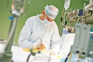 surgeon perform operation on a patient at heart surgery clinic